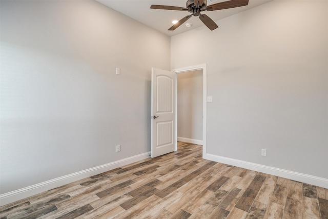 spare room with hardwood / wood-style floors and ceiling fan