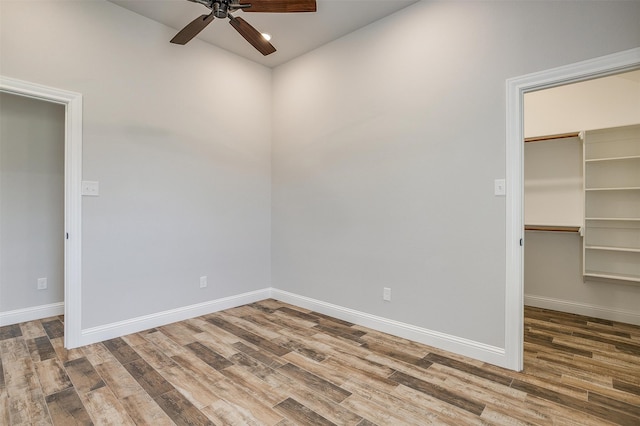 empty room featuring wood-type flooring and ceiling fan