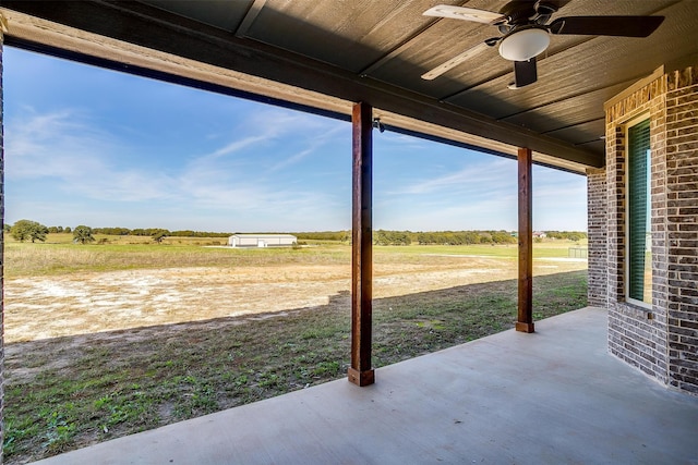 view of patio / terrace featuring ceiling fan and a rural view