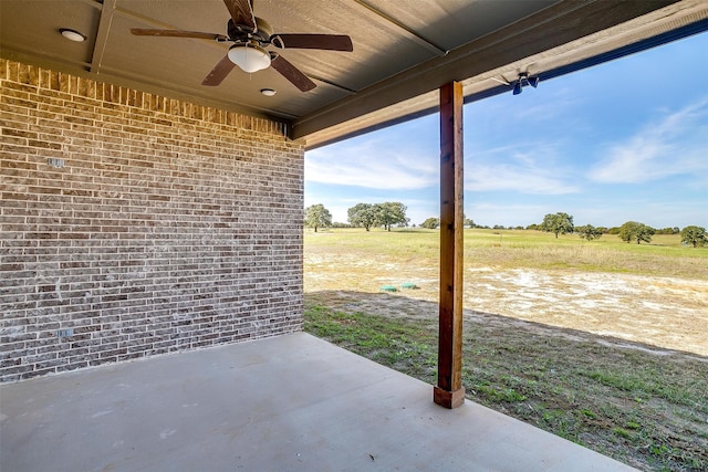 view of patio featuring a rural view and ceiling fan