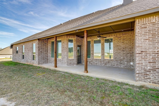 rear view of property with a yard, a patio, and ceiling fan