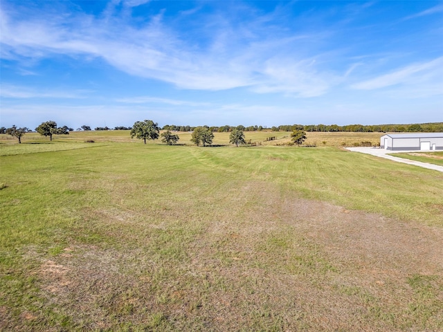 view of yard with a rural view