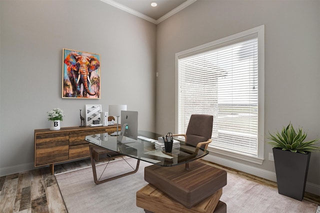 home office with light wood-type flooring, a wealth of natural light, and ornamental molding