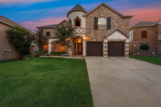 french provincial home with a garage and a yard