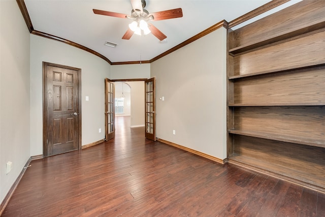 empty room with dark hardwood / wood-style flooring, ceiling fan, and crown molding