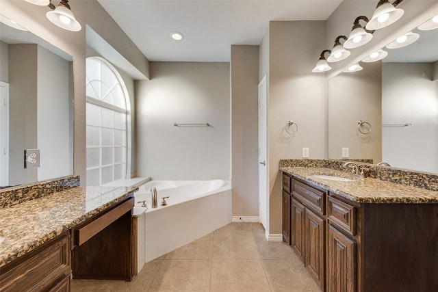 bathroom featuring vanity, tile patterned flooring, and a bathing tub