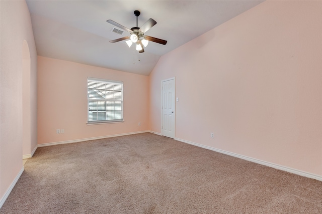 unfurnished room featuring light carpet, ceiling fan, and vaulted ceiling