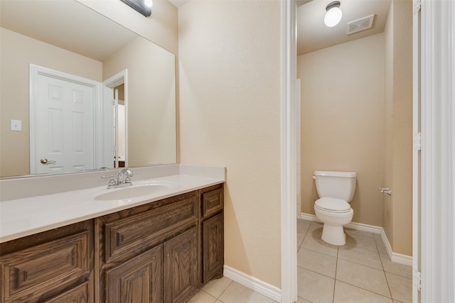 bathroom with vanity, tile patterned flooring, and toilet