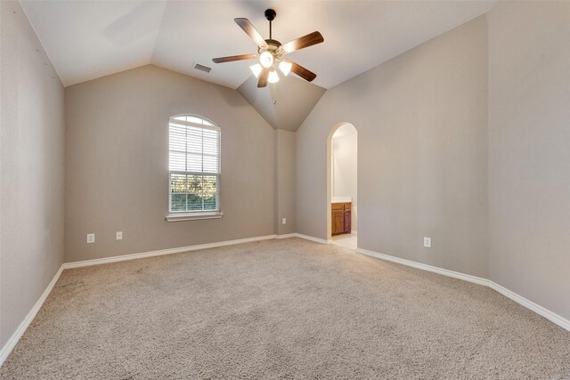 carpeted empty room with lofted ceiling and ceiling fan