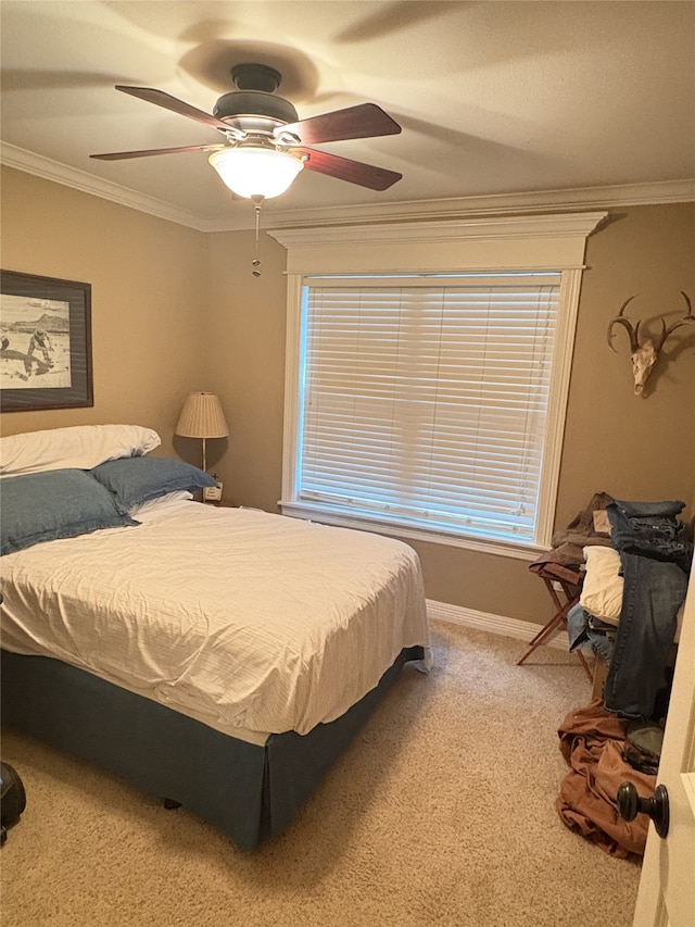 bedroom featuring carpet, ceiling fan, and crown molding