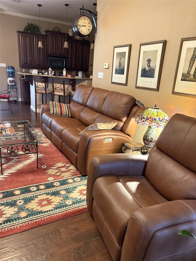 living room with dark hardwood / wood-style flooring and ornamental molding