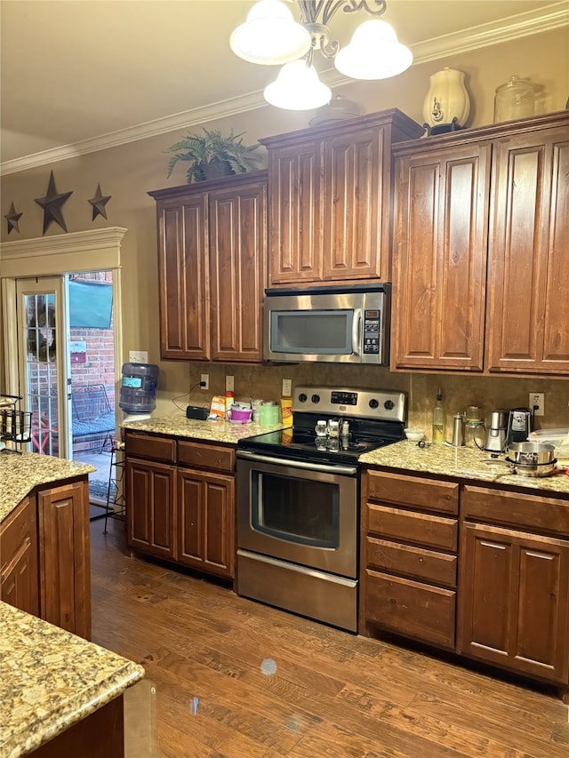 kitchen featuring stainless steel appliances, light stone counters, tasteful backsplash, crown molding, and dark wood-type flooring