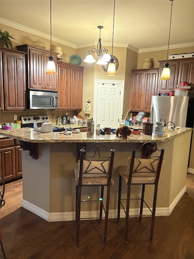 kitchen featuring stainless steel appliances, a kitchen island, a breakfast bar, and dark hardwood / wood-style flooring