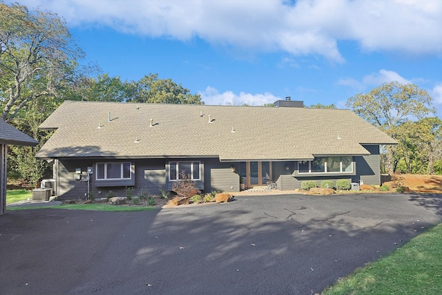 rear view of property with central AC unit