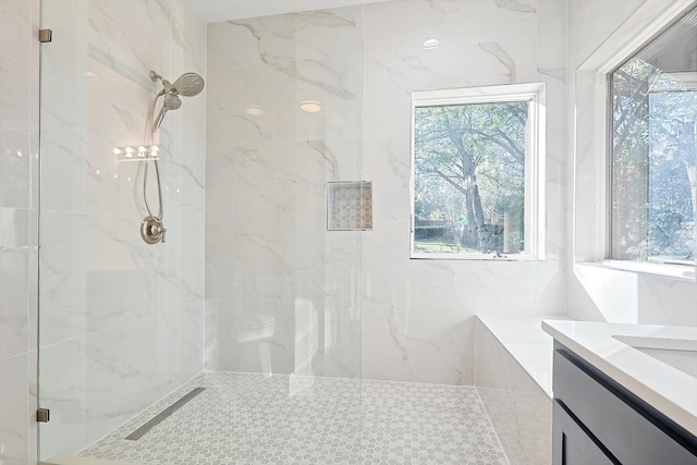 bathroom with walk in shower and vanity