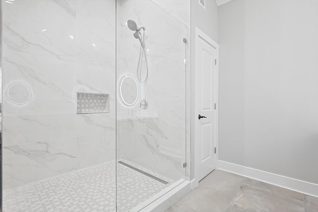 bathroom with a shower with door