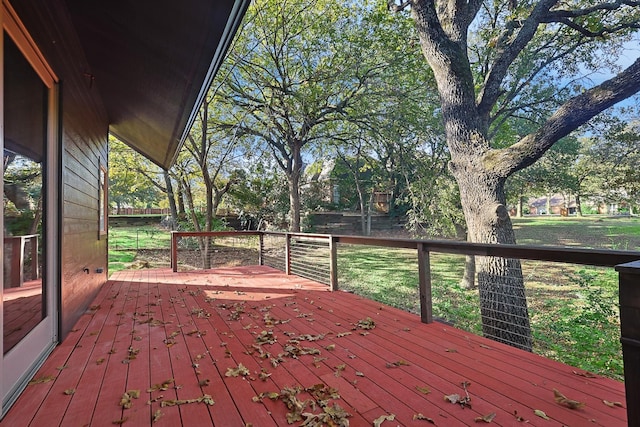 wooden deck featuring a lawn