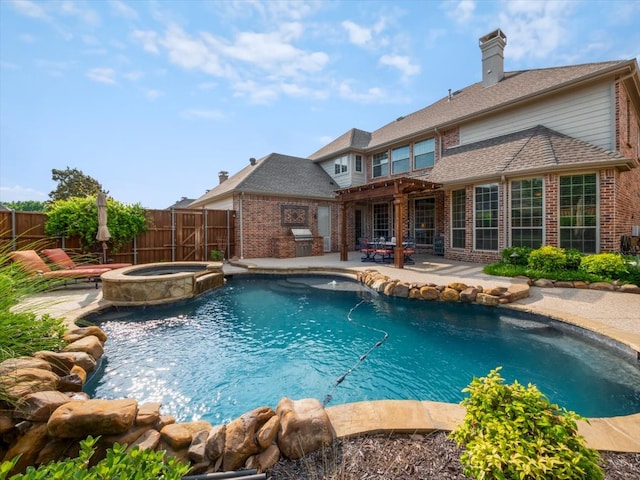 view of pool with an in ground hot tub and a patio