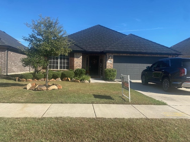 single story home featuring a front yard and a garage