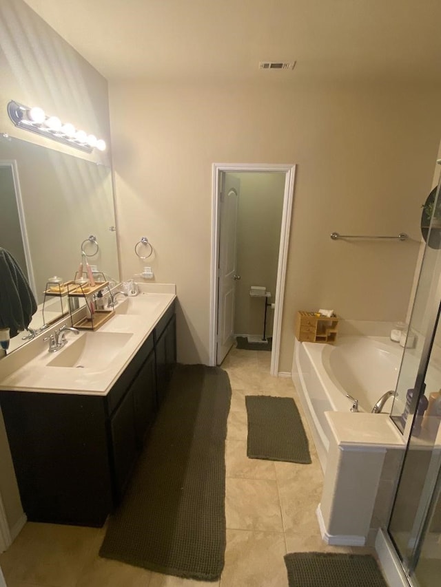 bathroom featuring vanity, tile patterned floors, and separate shower and tub