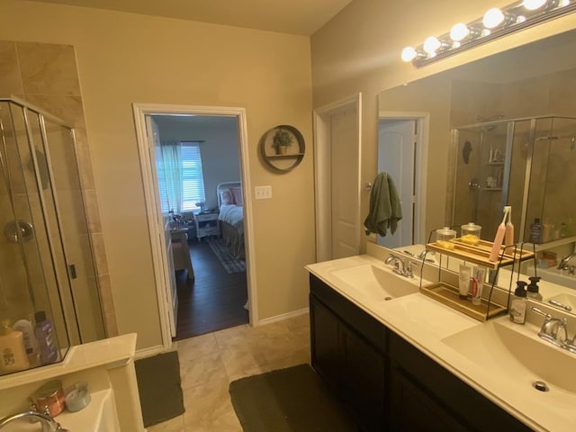 bathroom featuring tile patterned floors, vanity, and an enclosed shower