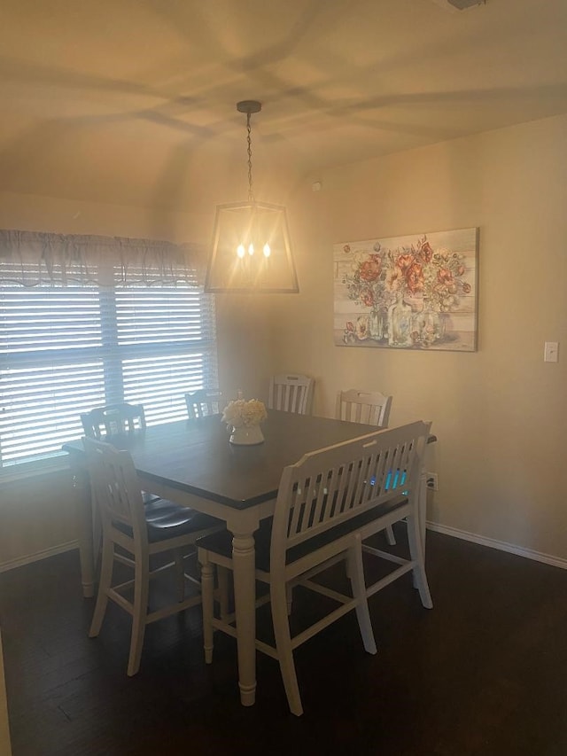 dining area featuring dark hardwood / wood-style floors and a notable chandelier