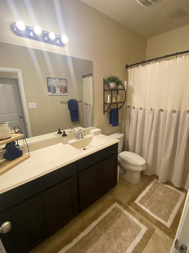 bathroom with tile patterned floors, vanity, and toilet