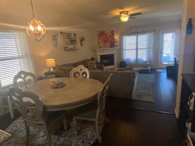 2748 Morning Song Dr, Little Elm, TX 75068 - dining room with a fireplace, a chandelier, wood finished floors, and ceiling fan