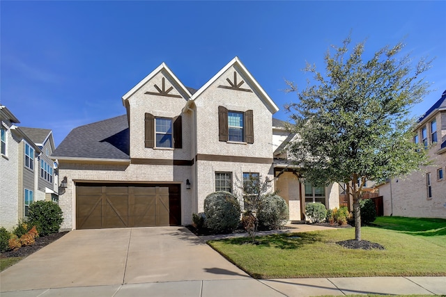 view of front of property with a front yard and a garage