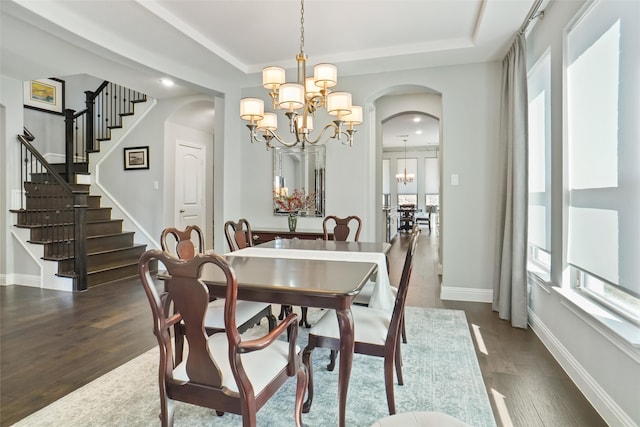 dining space featuring a chandelier and dark hardwood / wood-style flooring