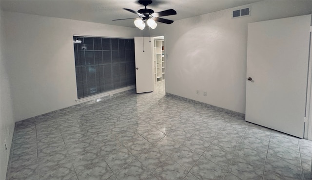 unfurnished room with ceiling fan