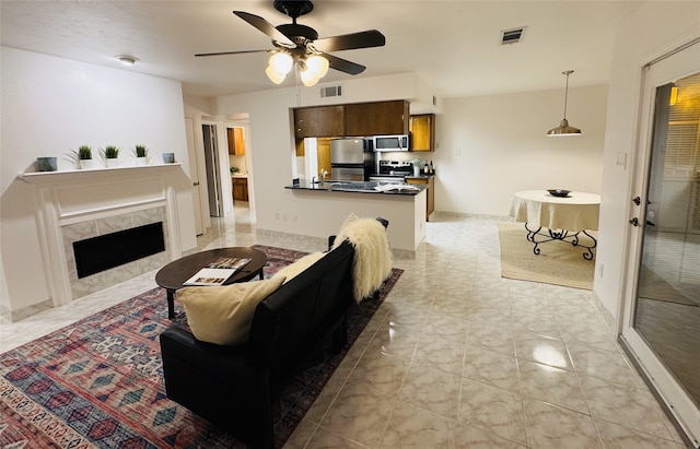 living room with ceiling fan and a premium fireplace