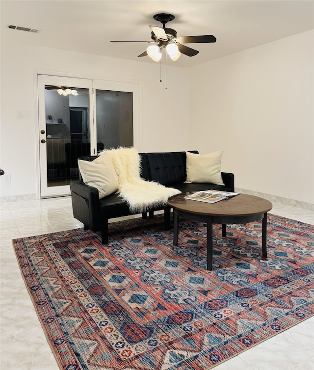 living room featuring ceiling fan and light tile patterned floors