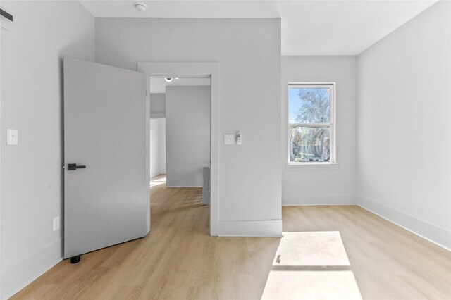 unfurnished bedroom featuring baseboards and wood finished floors