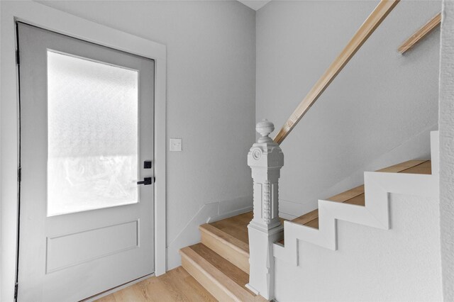 foyer with stairway and wood finished floors