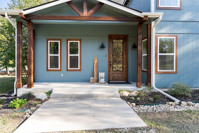 view of exterior entry with covered porch