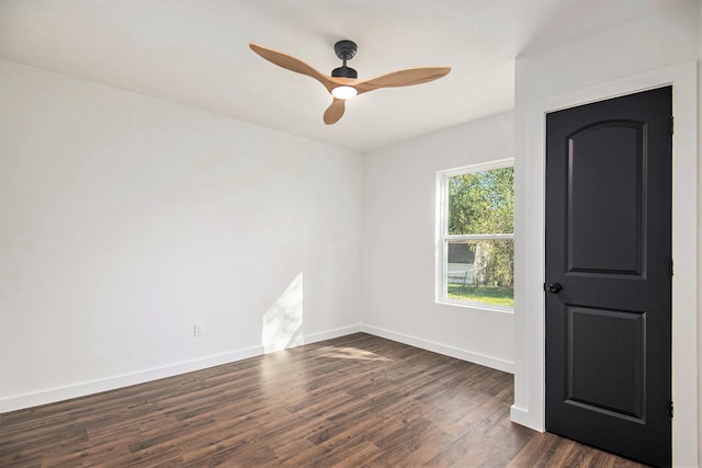 unfurnished room featuring ceiling fan and dark wood-type flooring