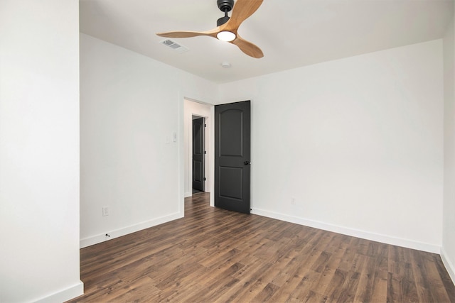 spare room featuring dark hardwood / wood-style floors and ceiling fan