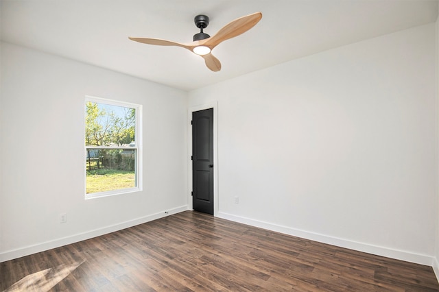 unfurnished room with ceiling fan and dark wood-type flooring