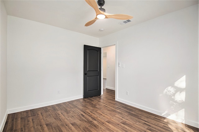 spare room featuring dark hardwood / wood-style floors and ceiling fan