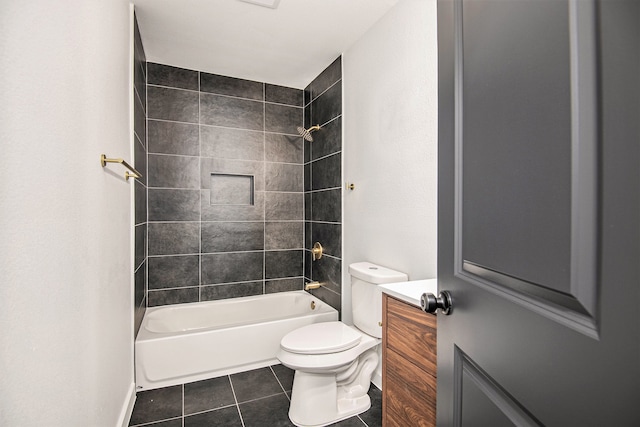 bathroom featuring toilet, tile patterned flooring, and tiled shower / bath