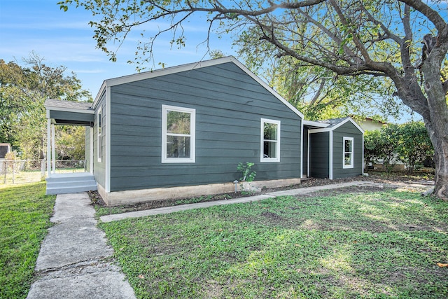 view of side of property with a lawn