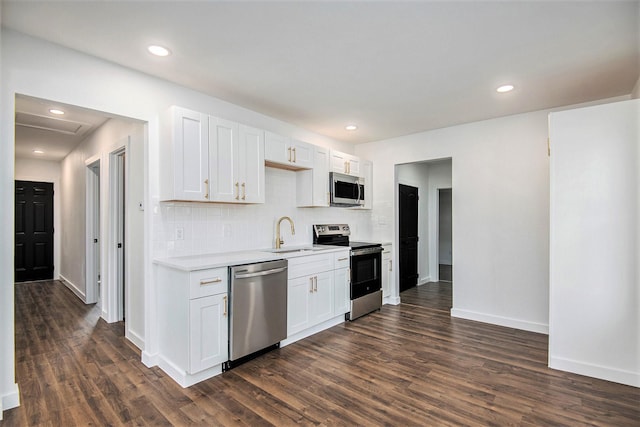 kitchen with white cabinets, dark hardwood / wood-style flooring, sink, and appliances with stainless steel finishes