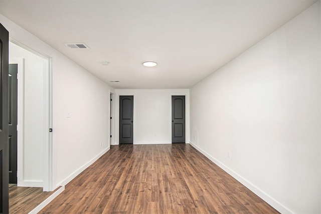 unfurnished room with dark hardwood / wood-style floors