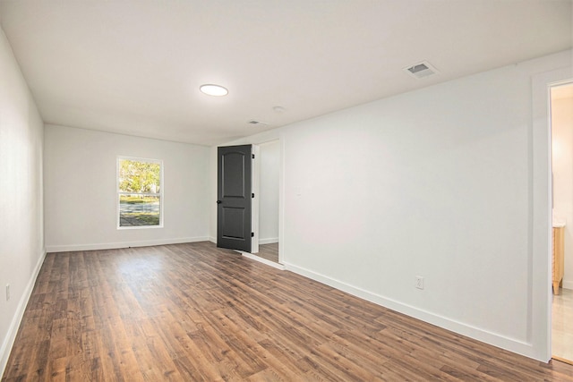 spare room featuring dark hardwood / wood-style floors