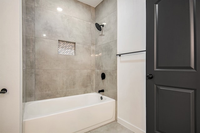 bathroom with tile patterned floors and tiled shower / bath