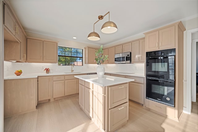 kitchen featuring black appliances, pendant lighting, backsplash, and light brown cabinets