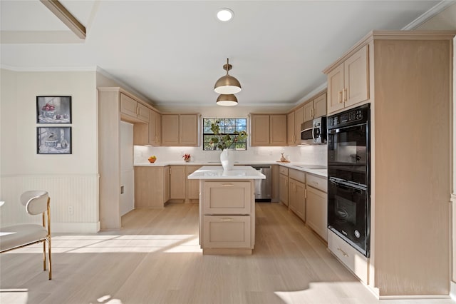 kitchen with light brown cabinetry, a center island, black appliances, and light wood-type flooring