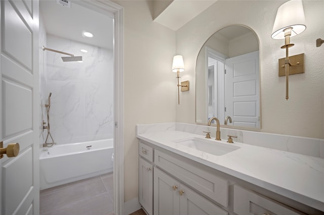 bathroom with tile patterned flooring, vanity, and tiled shower / bath combo