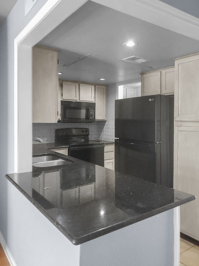 kitchen featuring sink, tasteful backsplash, kitchen peninsula, light tile patterned flooring, and black appliances